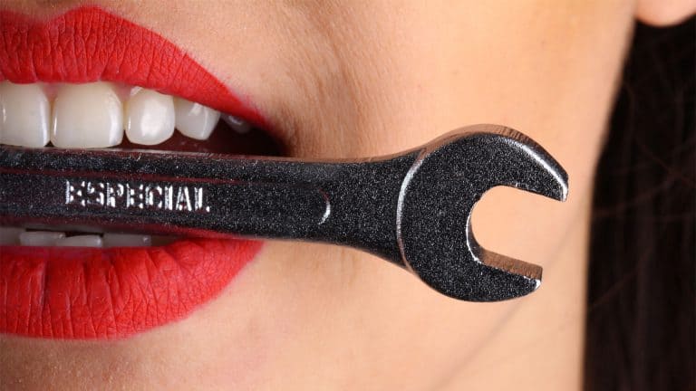 Girl with wrench in her mouth
